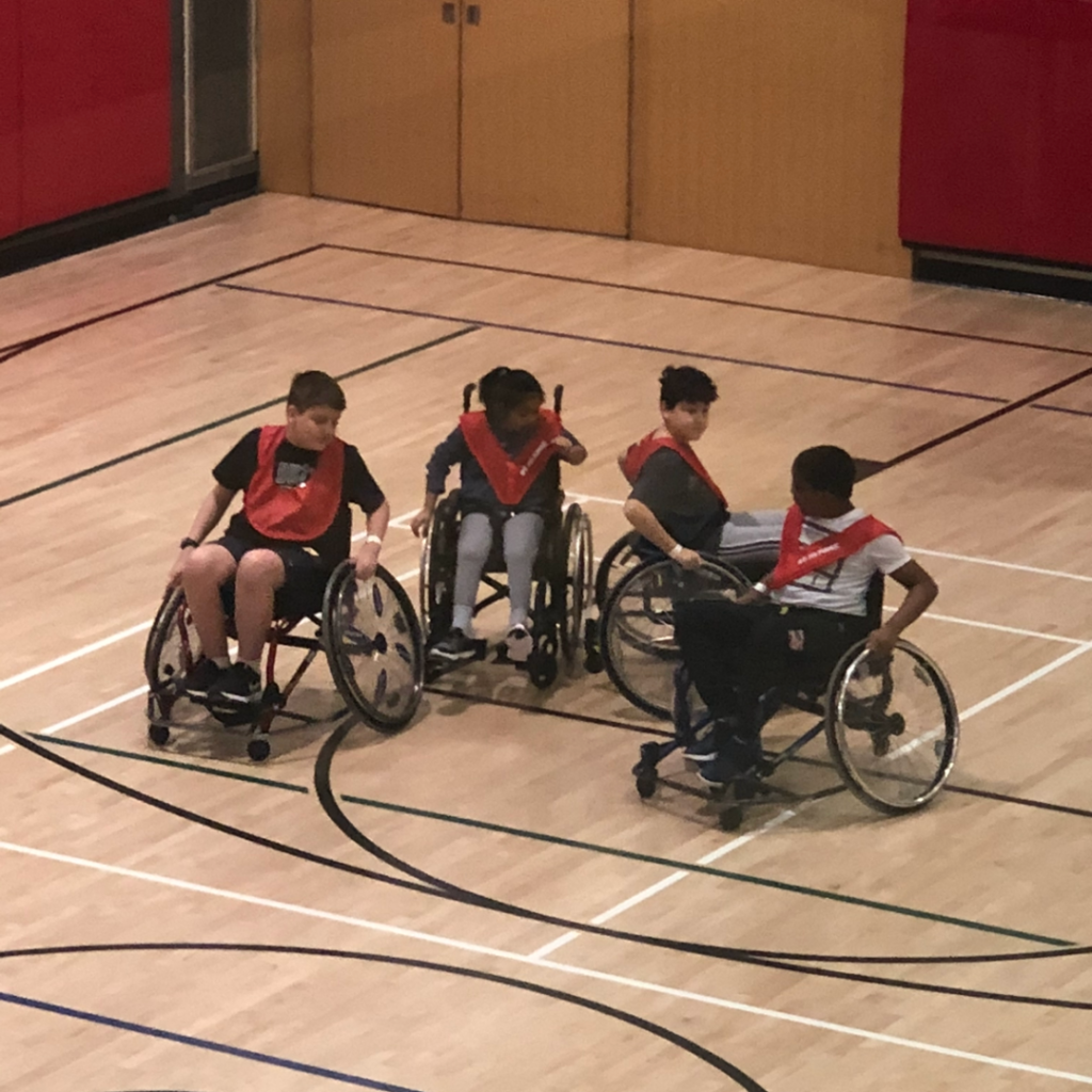 Claudia's son, Reid, playing wheelchair basketball with his friends.