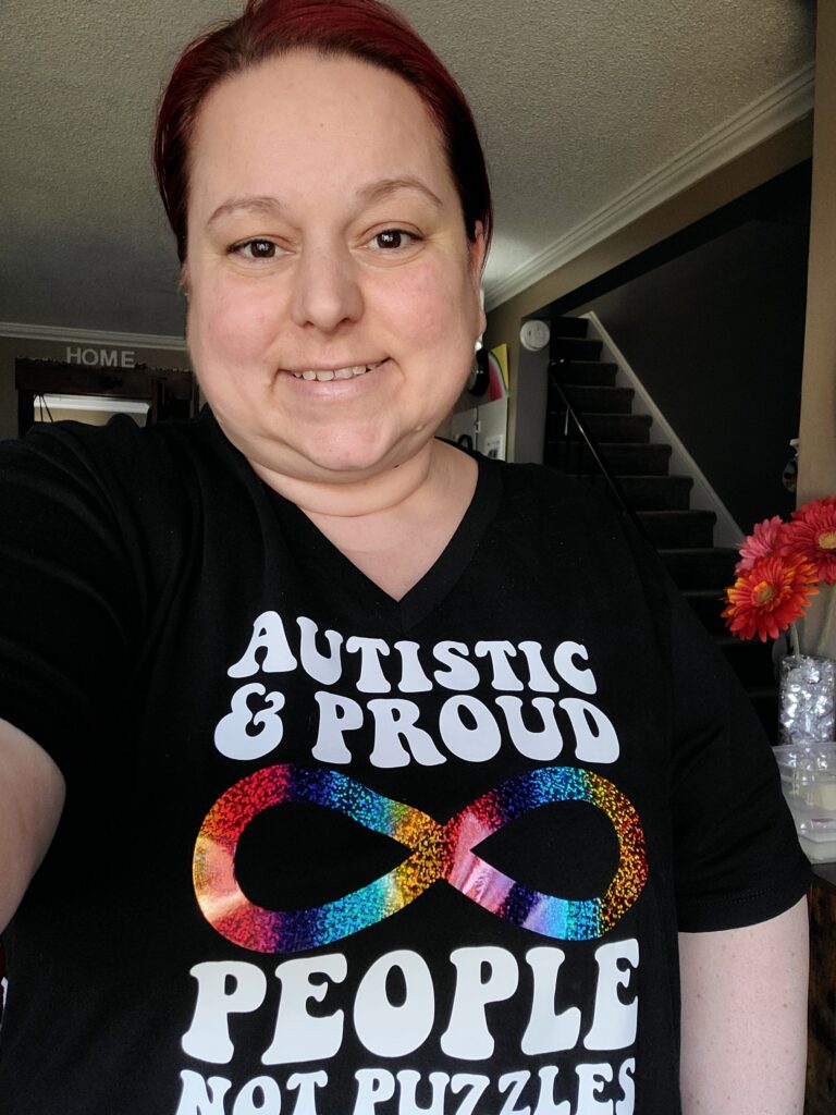 Natasha wearing an Autistic and Proud t-shirt.