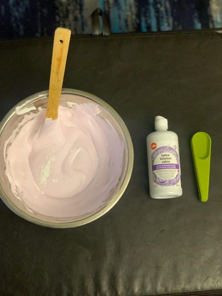 The mixture of the slime ingredients in a clear bowl. 