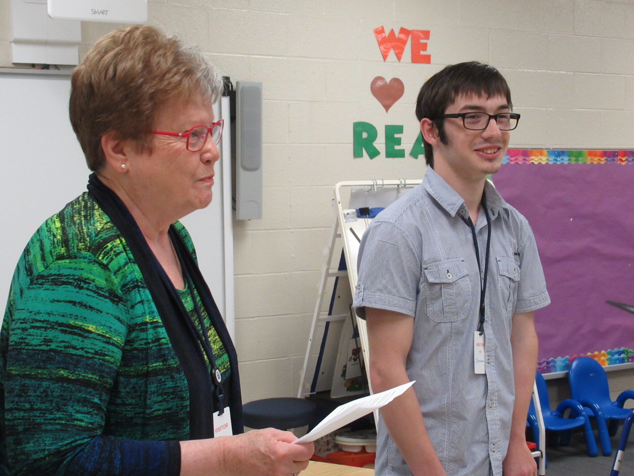 Sam smiles as Ruth presents award