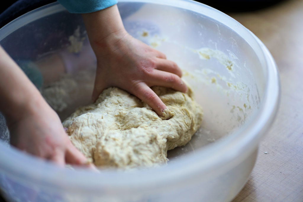 Picture of a person kneading dough. 