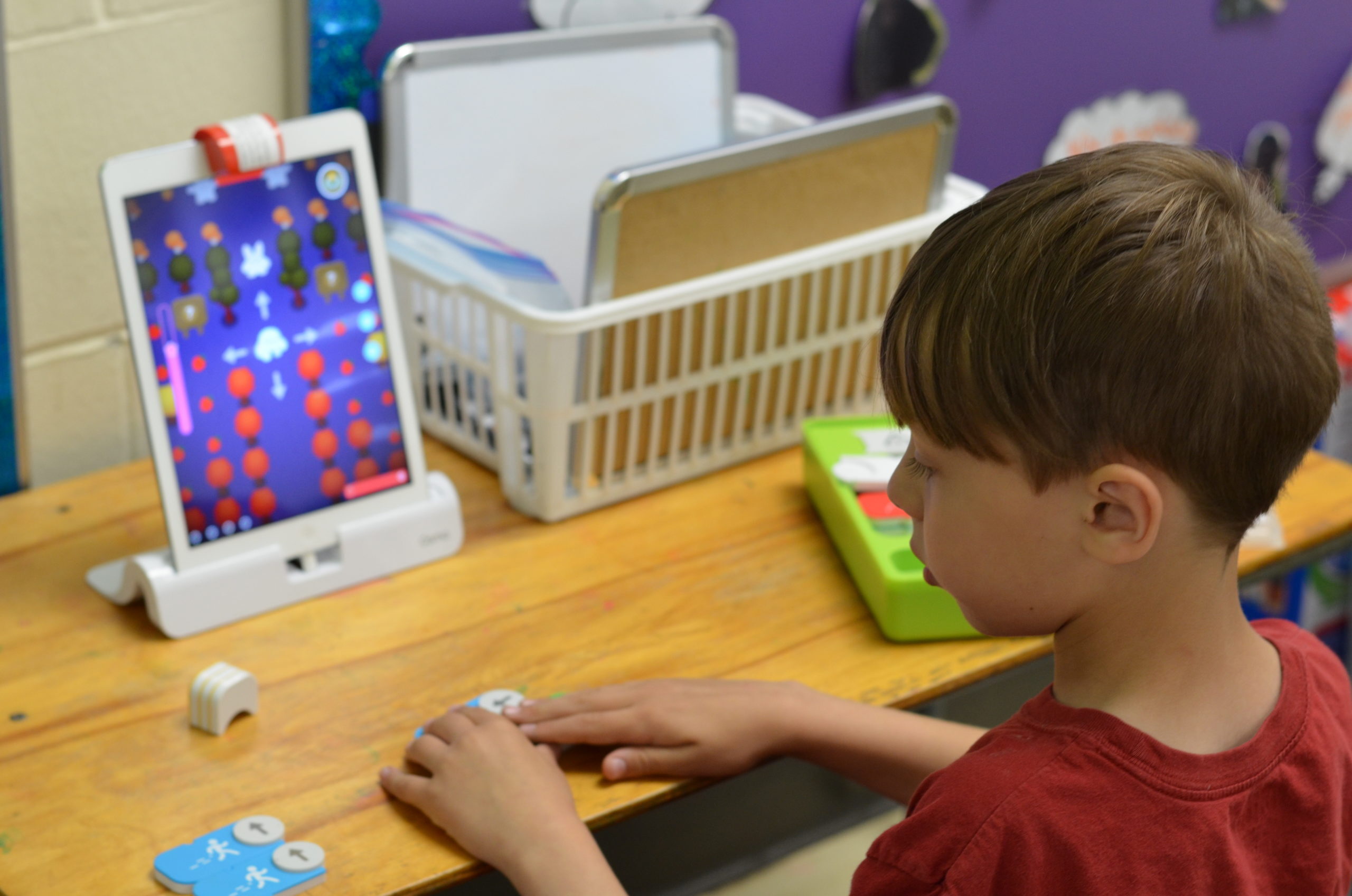 Little boy playing a game on an iPad