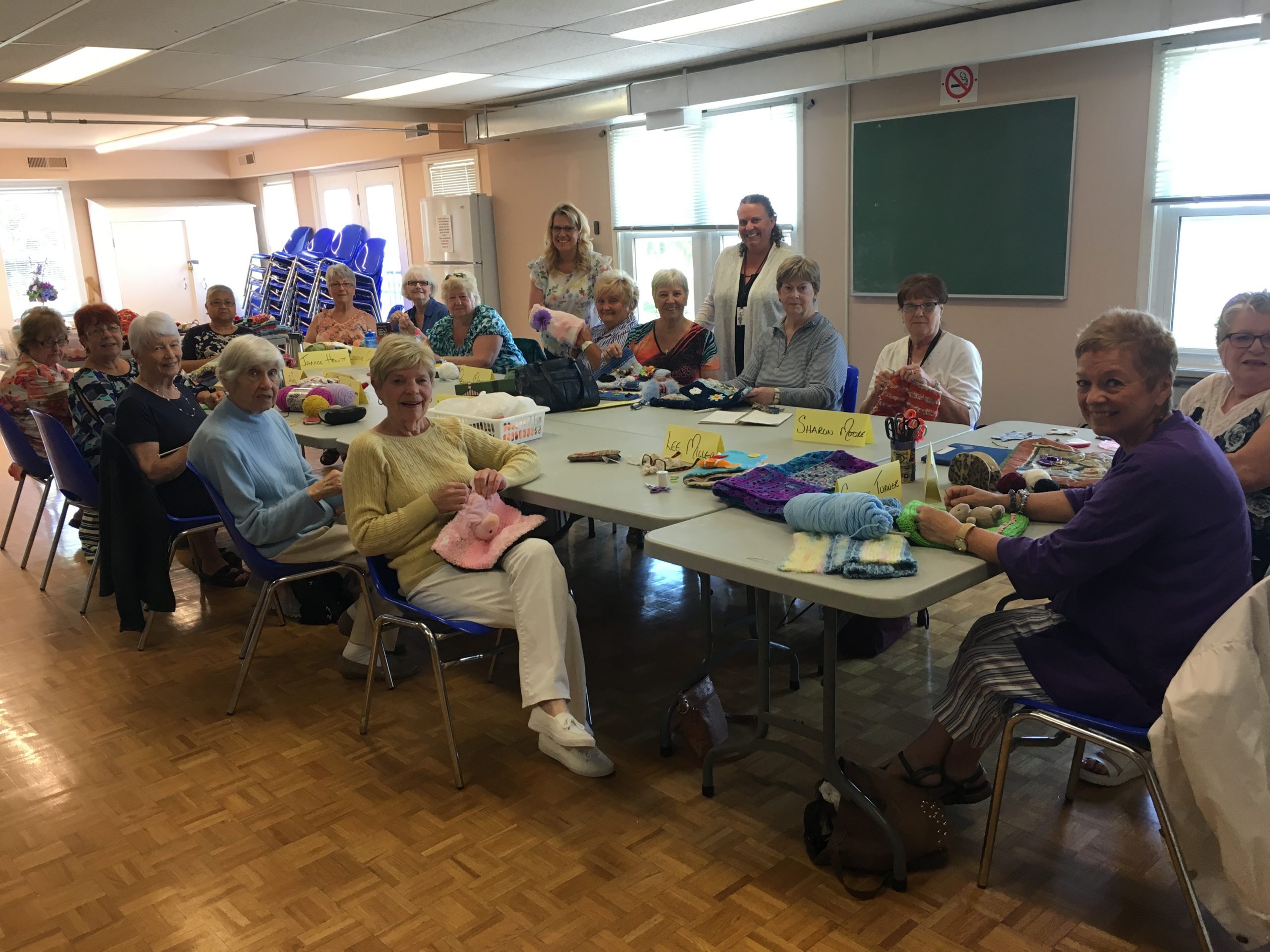 Crafters at their stations creating fidget muffs for Grandview Kids