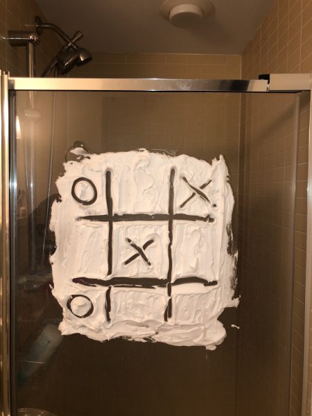 A game of tick-tack-toe etched into shaving cream. 