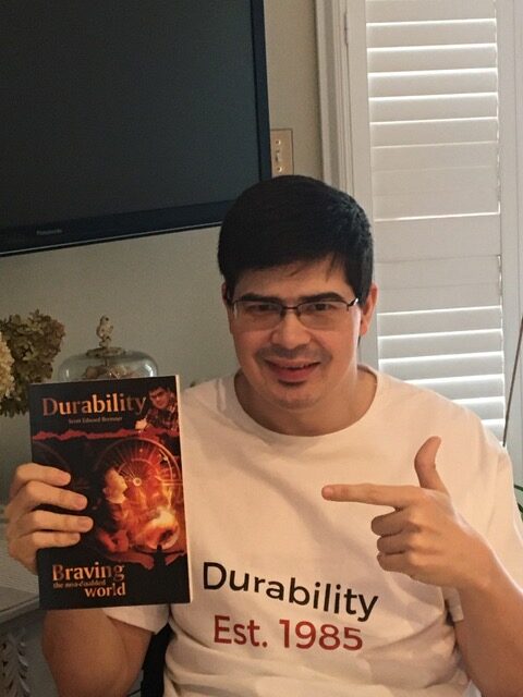 Scott, author of Durability, holding up his book, Durability.