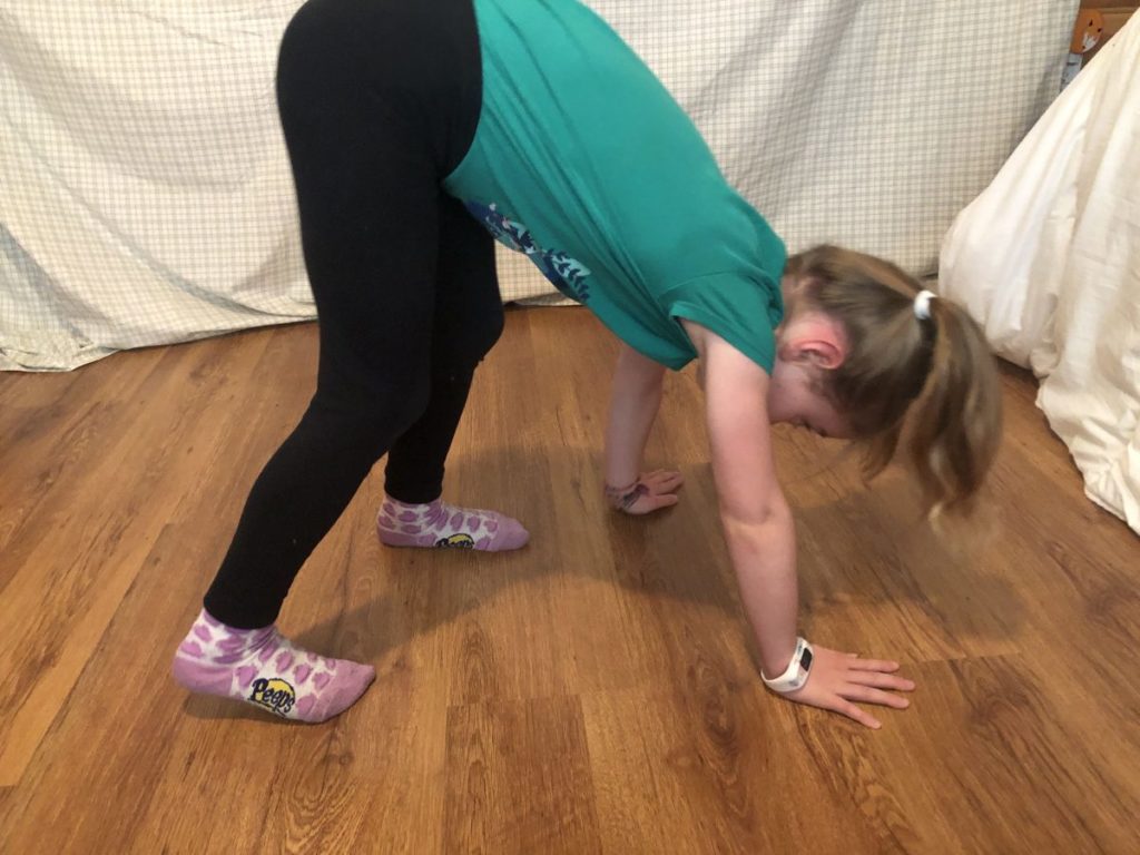 A girl displaying a bear walk