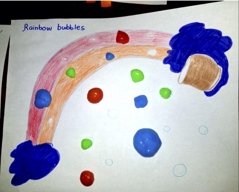 Drawn rainbow with colourful putty bubbles dotted across it.