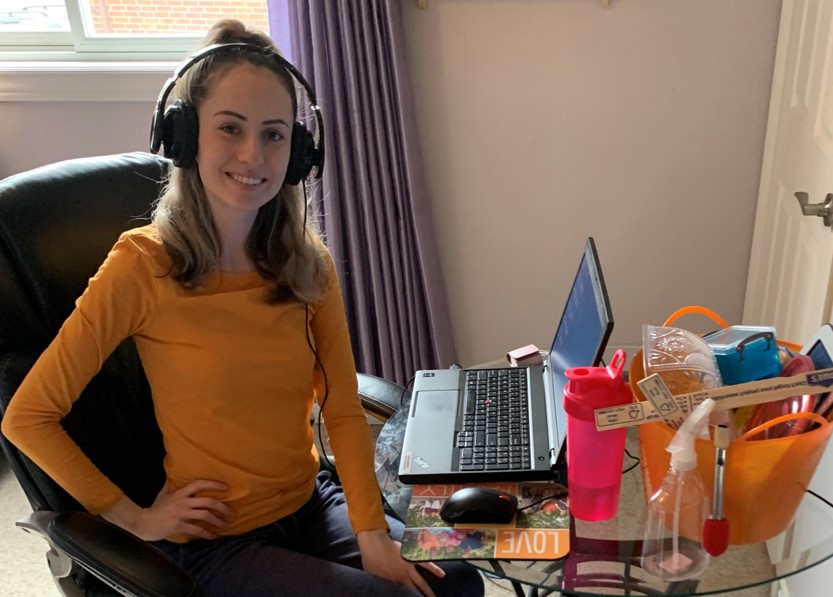 Grandview Kids staff member posing and smiling at desk while working from home