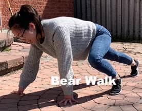 Woman acting out a bear walk motion.