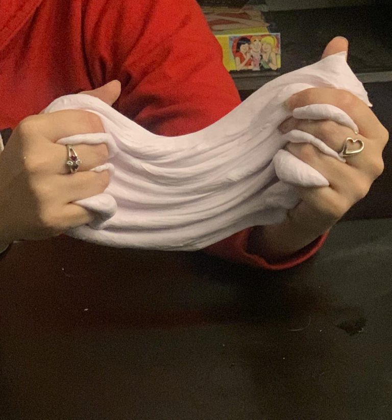 A person stretching fluffy slime with their hands.