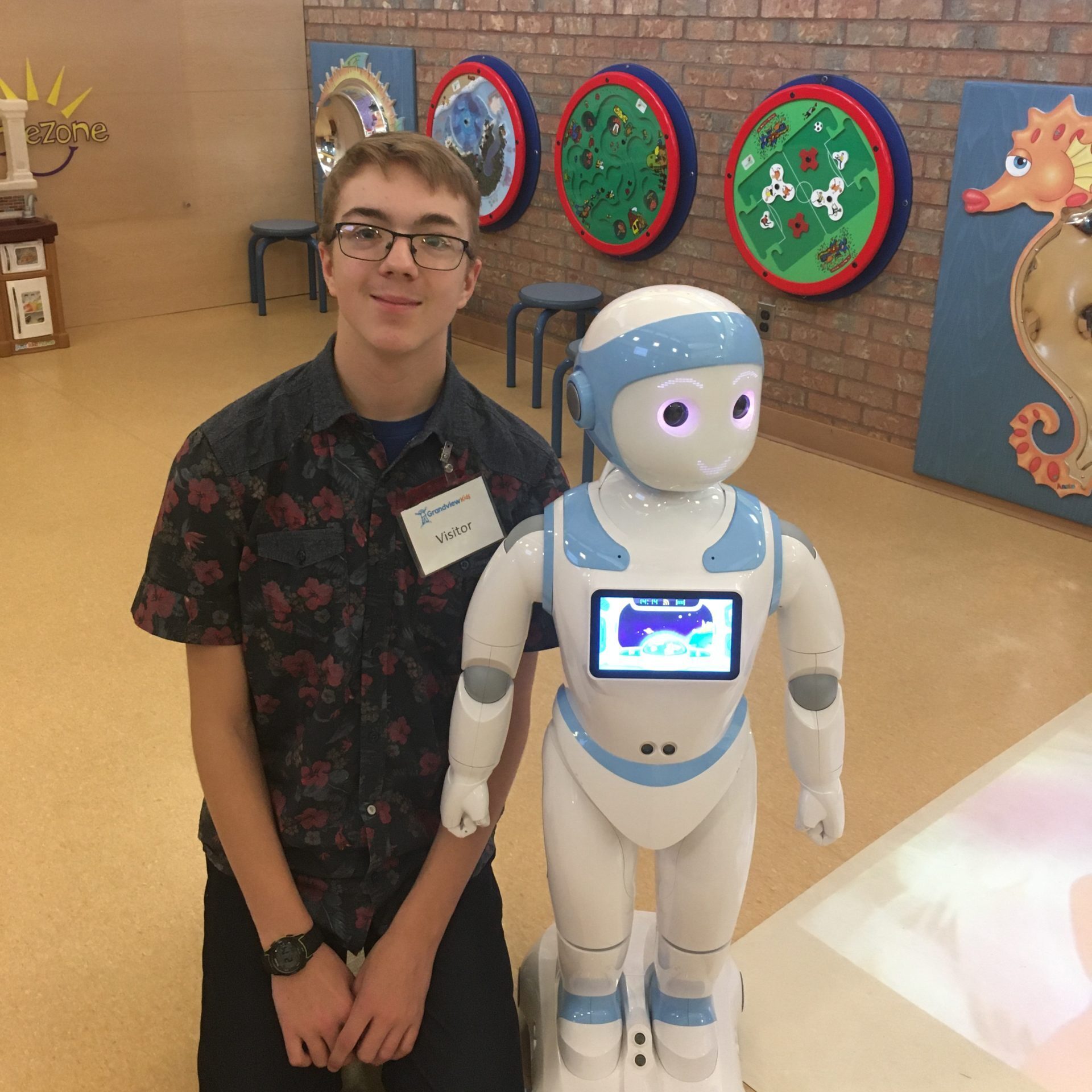 Joy the robot posing with Ethan at Grandview