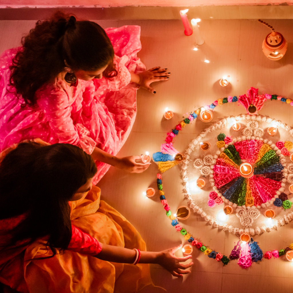 Women lighting candles in honour of Diwali.