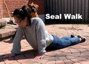 Woman acting out a seal walk motion.