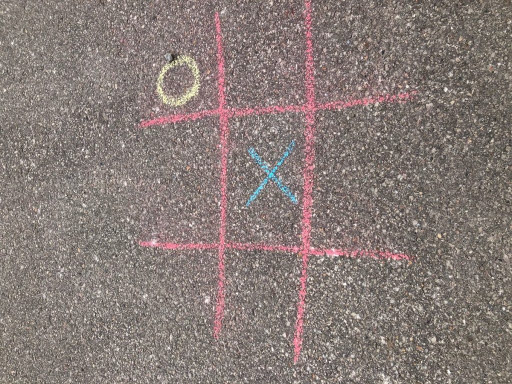 A picture of a tick-tack-toe sidewalk chalk game.